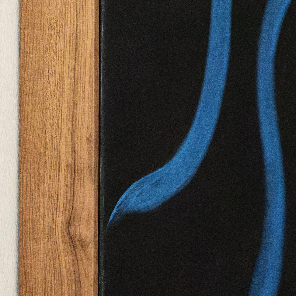 Close-up of artwork mounted on wood frame